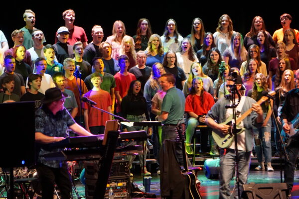 Mr. Tyrel Ivie leads a Central Utah choir at the rock concert.