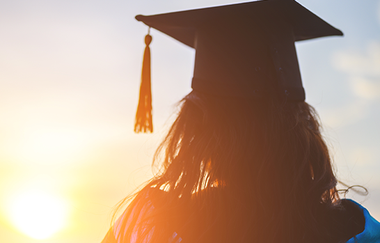 A graduate watching the sunset