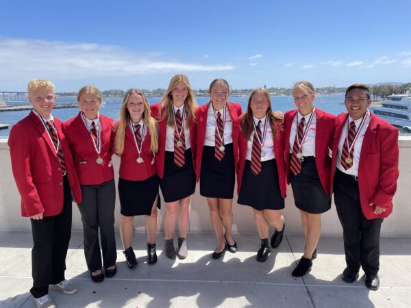 students dressed up in red suitcoats and ties