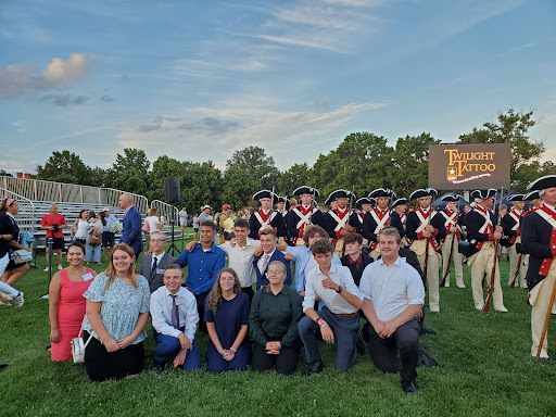 The Panguitch TARs at the Twilight Tattoo Pageant. Men dressed like Revolutionary War soldiers stand in the background.