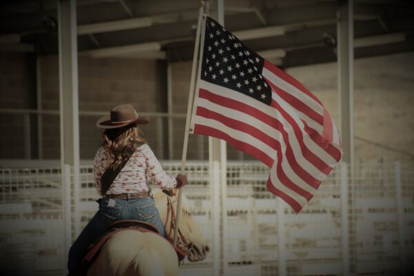 Sandy Allred rides with the American flag