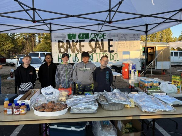 A group of 6th graders holding a bake sale.
