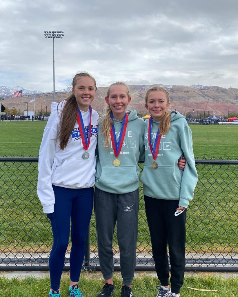 Adelaide, Tabi, and Brooke pose with their medals.