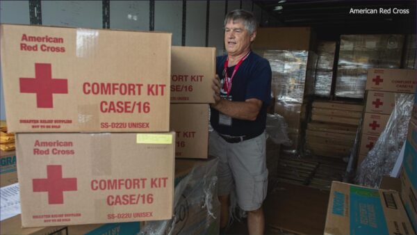 A red cross employee ships boxes for hurricane relief