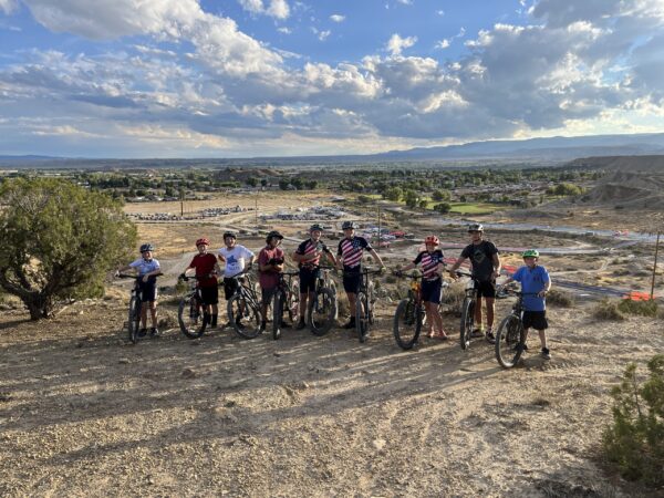 Panguitch mountain biking team with bikes and uniforms.