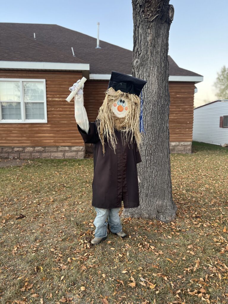 scarecrow graduating in a cap and gown