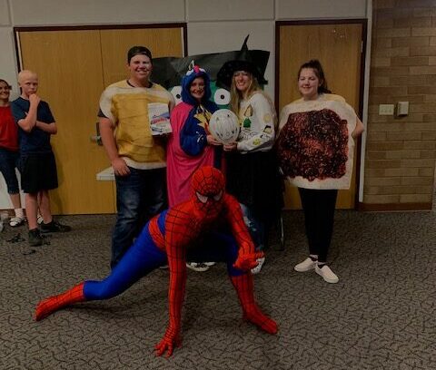 The student council, dressed-up for the Halloween party, poses for a photo.