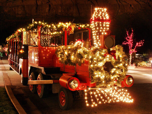 Tuacahn's train all lit up with Christmas lights and wreaths.