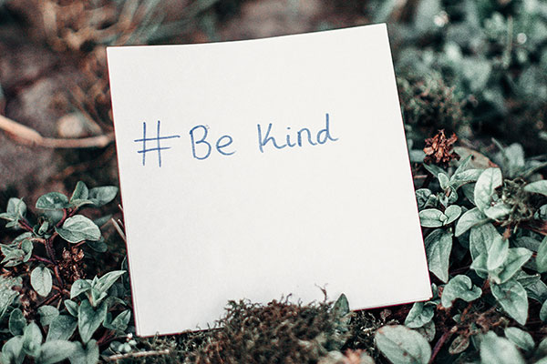 "Be Kind" written on a post-it note