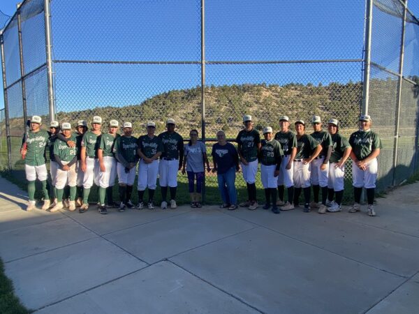 Britnee and Sharlene Littlefield pose with the Mustang baseball team after a game.