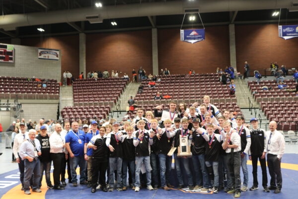 The Panguitch wrestling team holding medals and state trophy at the SVC.