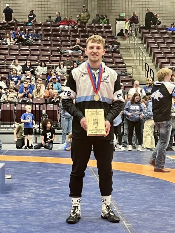 McKray poses with his outstanding wrestler award.