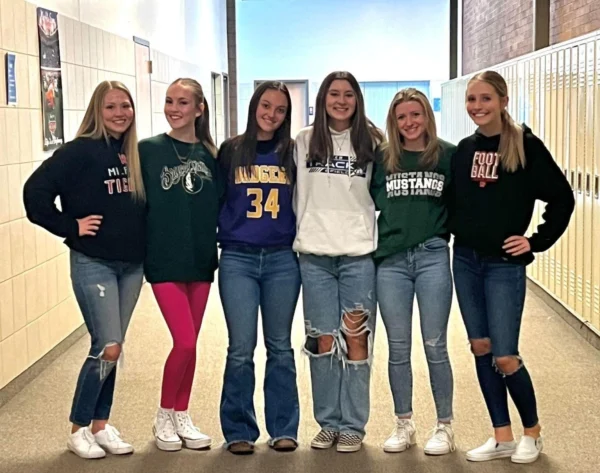 Six girls wearing sweatshirts and jerseys from different schools in the region.