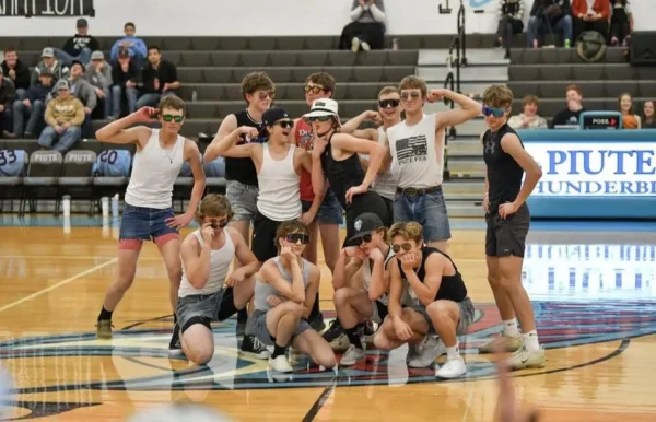 Piute boys, dressed like gangsters, dancing at the Homecoming games.