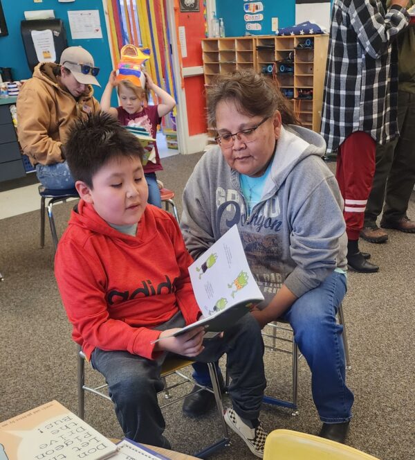 A woman and child reading together.