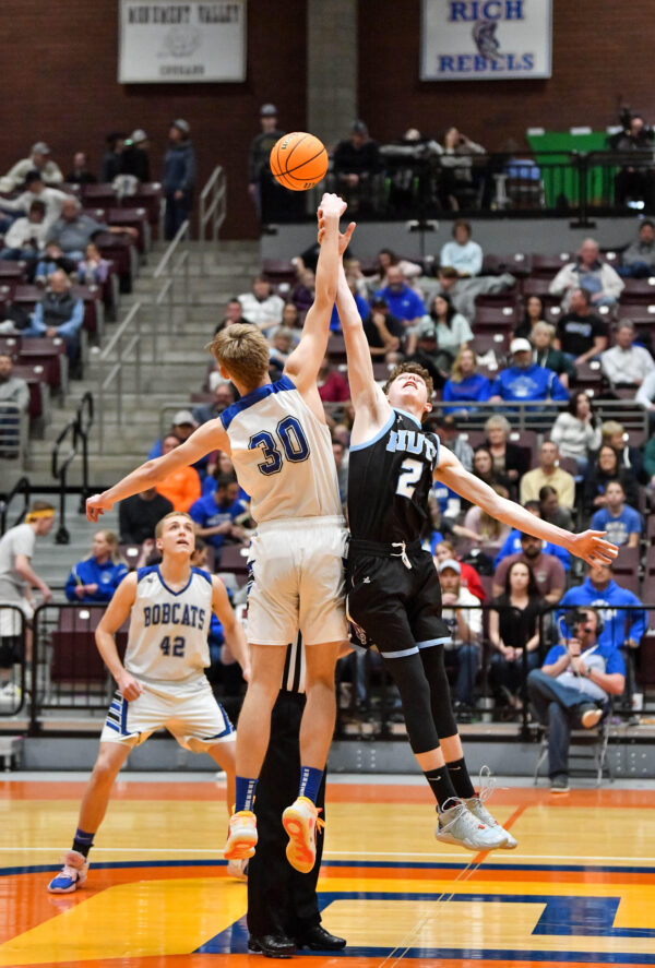 Panguitch and Piute boys jump for the basketball.