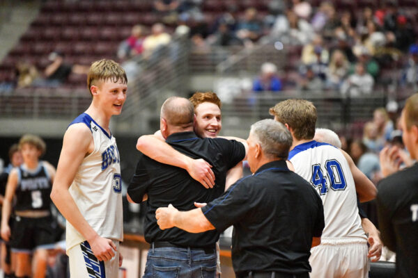 Players hug their coaches after the game.