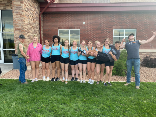 Piute's cheer team does a power pose in front of the high school.
