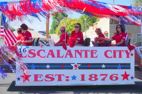 A red, white, and blue float with the words, "Escalante City. Est. 1876."