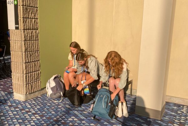 Emma, Ari, and Brooklyn in the hall getting their stuff out.