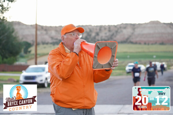 Bill Scoffield announces the beginning of the race through an orange traffic cone.