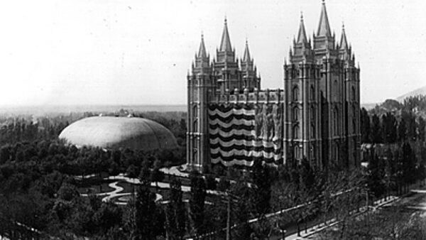 A giant United States flag hangs on the Salt Lake Temple.