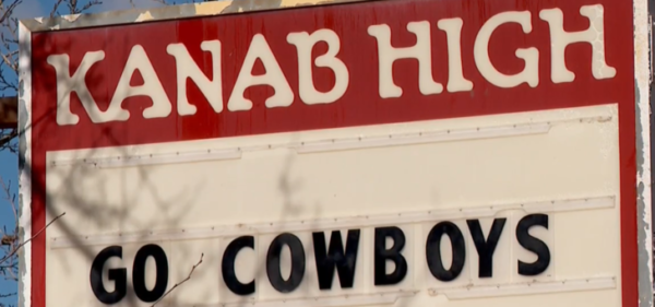 Sign reading, "Kanab High. Go Cowboys."