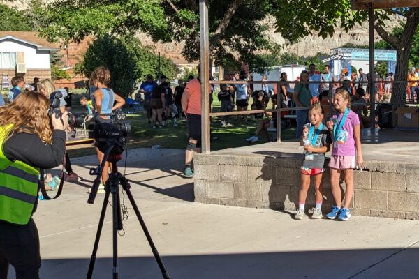 Some young girls show off their medals for the camera.