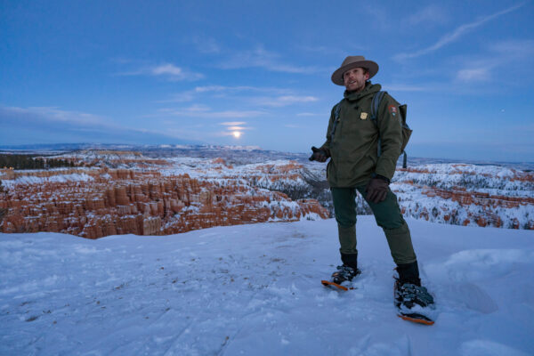 Peter Densmore in snowshoes looking over Bryce Canyon in the early morning.