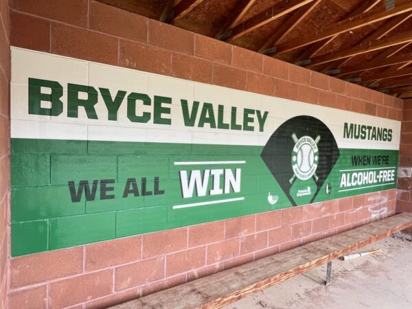 "We all win when we're alcohol free" signage in a Bryce Valley baseball dugout.