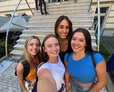 A selfie of McKynlee and three other girls in front of the New York University steps in Prague.