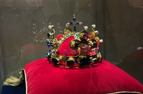 The bohemian crown jewels sitting on a red velvet pillow.