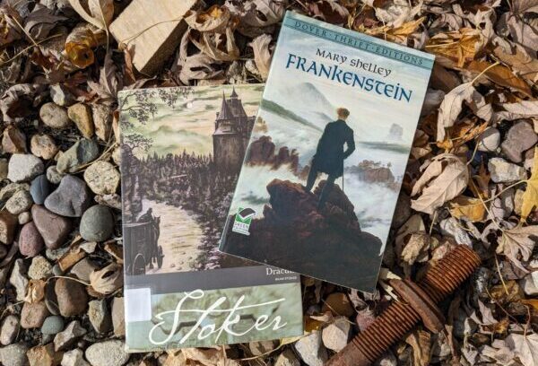 "Frankenstein" and "Dracula" books sitting out in leaves.