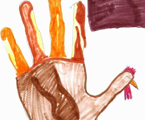 A kid's drawing of a turkey hand (a hand traced and colored like a turkey).