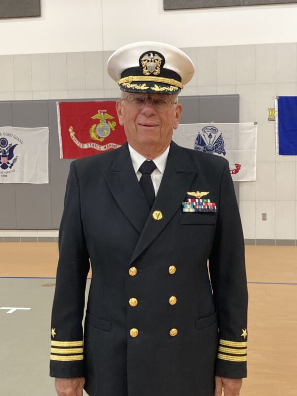 An elderly man wearing a navy uniform.