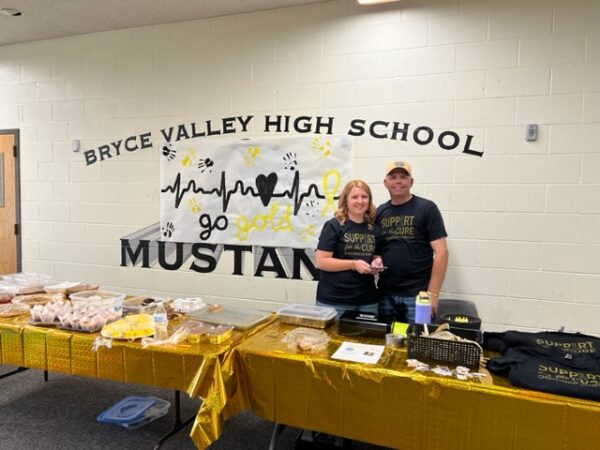 Shayne and Klay Chynoweth work at a bake sale.