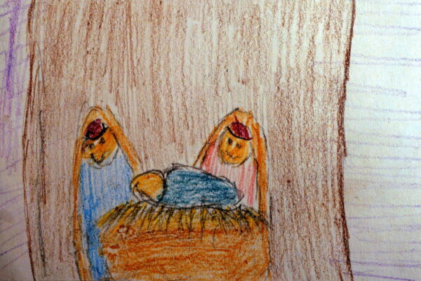 A kid's crayon and pencil drawing of the manger scene. Above the hay-covered roof is a star shining. Inside, the rounded heads of Mary and Joseph look at the baby Jesus in the manger.