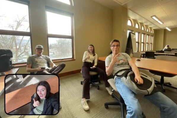 Four college students on campus in a BeReal picture.