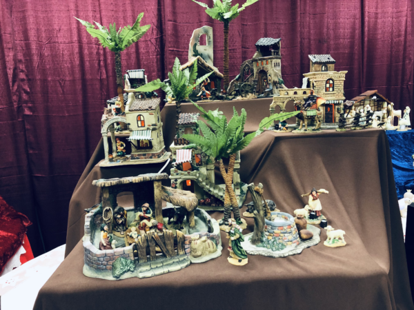 A couple of very involved nativity sets feature whole towns of palm trees, inns and people, each with a manger scene. People work, some take care of animals, and a woman gets water at a well.