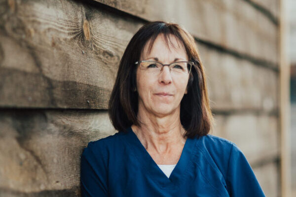 Portrait of Susan Harris in hospital scrubs.
