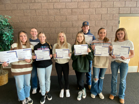 Eight Piute FBLA members hold up certificates of awards.