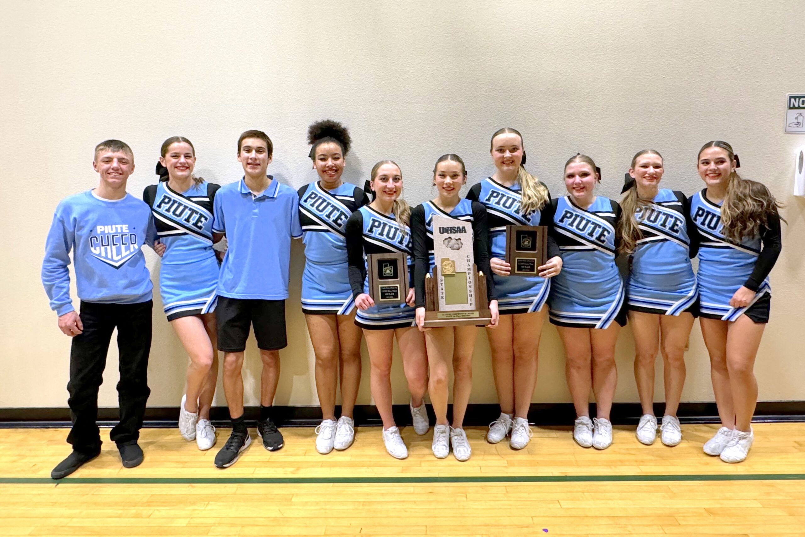 The Piute cheer team with their state championship trophy.