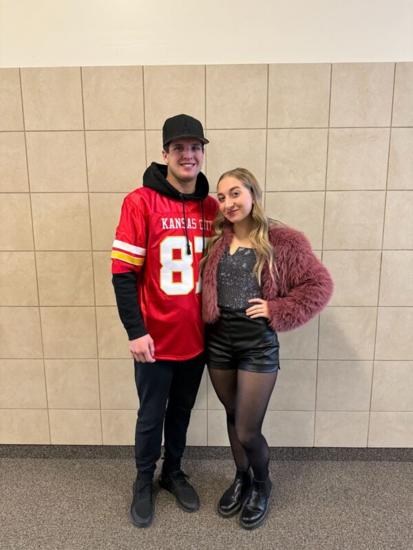 A high school couple dressed as Travis Kelce and Taylor Swift.