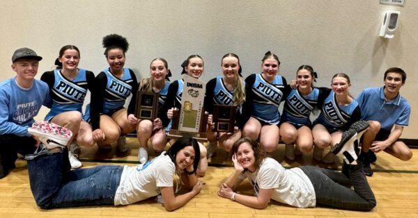 The Piute cheer team and their coaches with their state championship trophy.