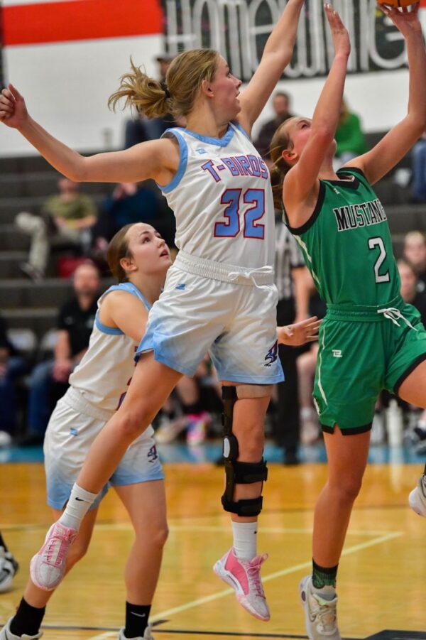 A Piute basketball girl blocks a layup from a girl from Bryce Valley.