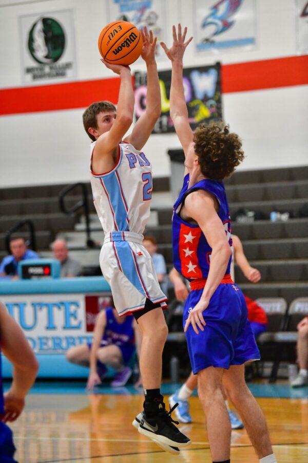 A Piute basketball boy goes up against a boy from Mt. Vernon.