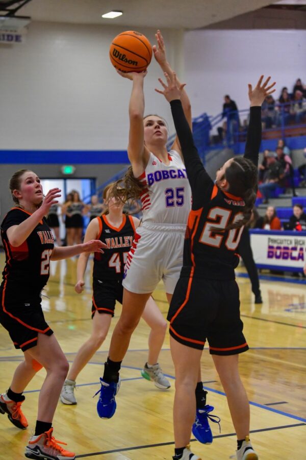 Girls basketball players from Valley try to defend the hoop as a Panguitch player goes in for a lay-up.