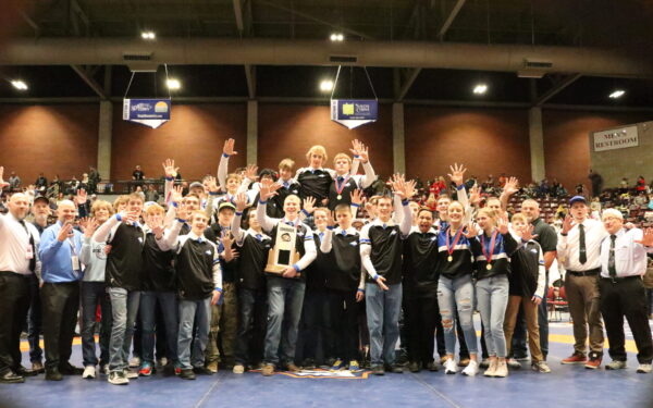 The Panguitch wrestlers pose with their trophy, holding up a number five on their fingers for the 5th year in a row winning the championship.