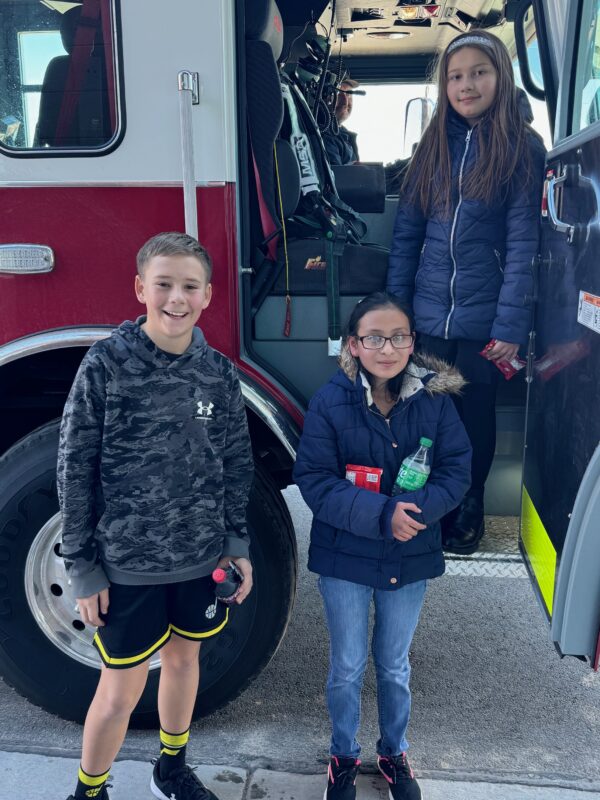 The winners of the spelling bee getting ready for a ride in the fire truck.