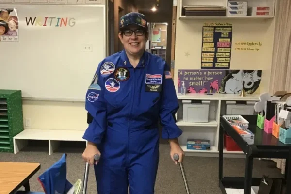Jaime Catlett in a kindergarten classroom. Jaime uses armband crutches to support herself.